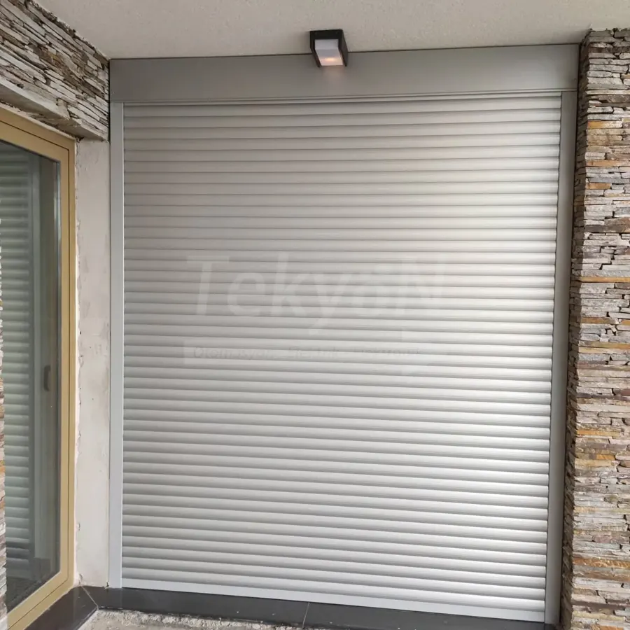 Teras kapısında gümüş gri alüminyum motorlu panjur – TekyöN Otomasyon